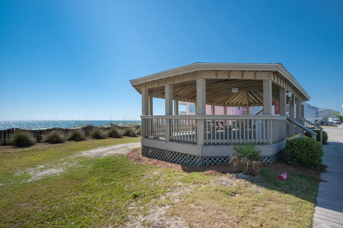 A scenic gazebo overlooking an expansive ocean view, with a landscaped walkway leading to the vantage point. The peaceful setting invites romantic walks, picnics, or quiet moments together while taking in the coastal beauty.