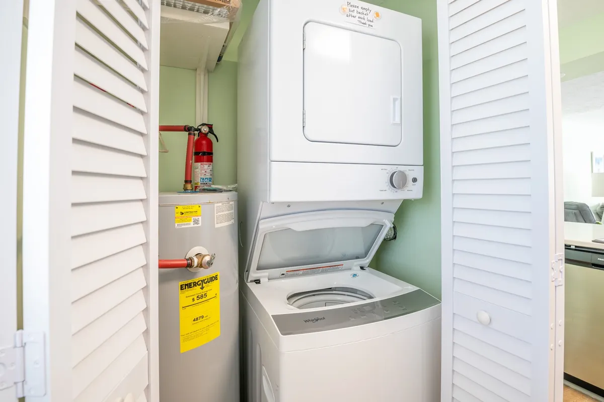 This image displays an in-unit laundry setup with a washer and dryer, utility equipment, and practical storage. The area looks clean, efficient, and conveniently located for easy daily use.